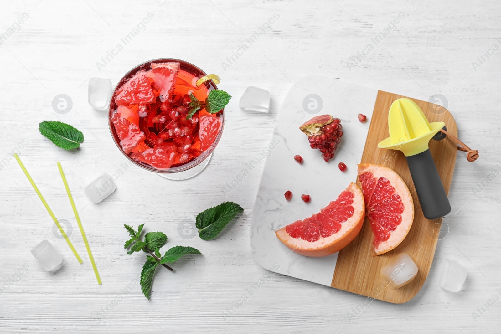 Photo of Flat lay composition with tasty refreshing cocktail on white wooden background