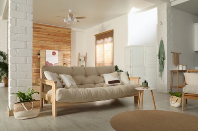 Photo of Spacious room interior with stylish wooden sofa and table. Idea for design