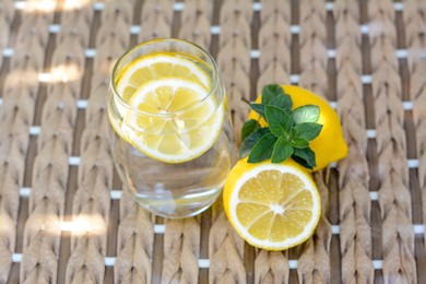 Refreshing water with lemon and mint on glass table