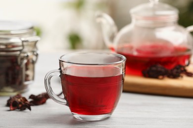 Photo of Delicious hibiscus tea on white wooden table