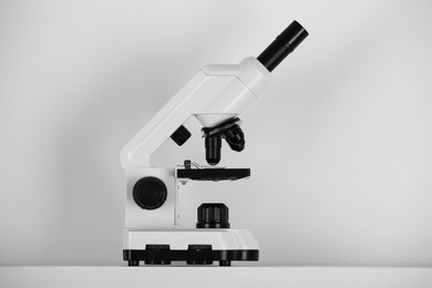 Photo of Modern microscope on light background. Medical equipment