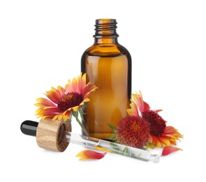 Bottle of essential oil and flowers on white background