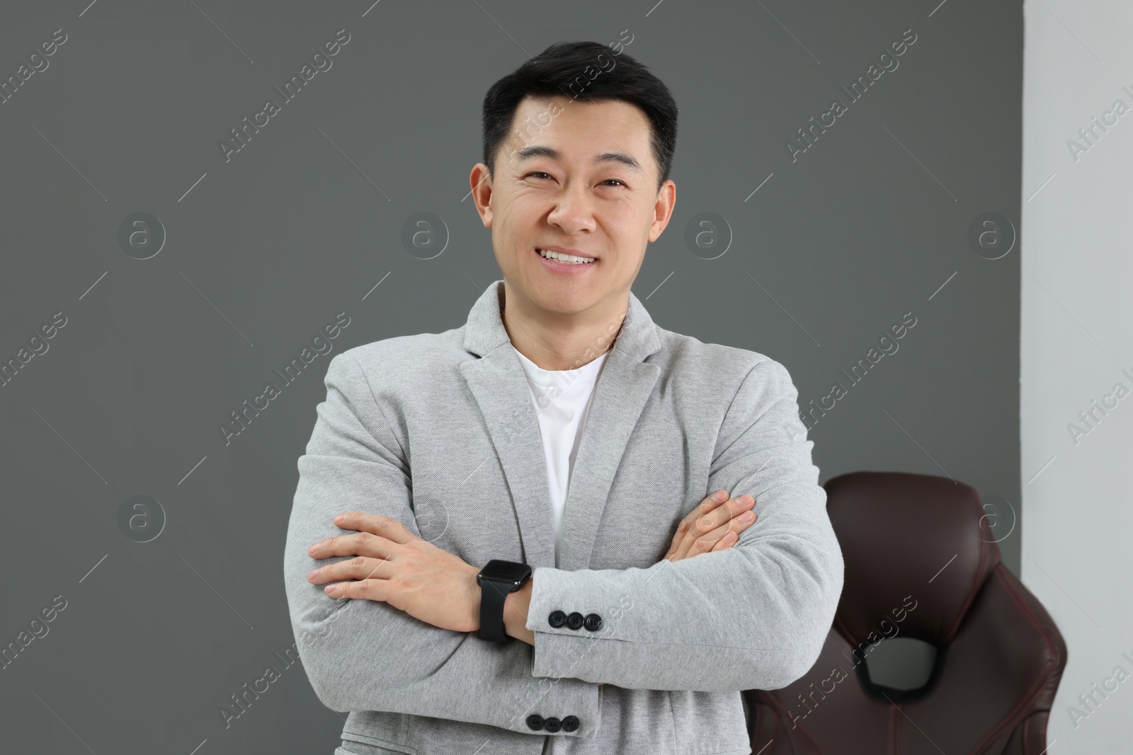 Photo of Happy successful boss in his modern office