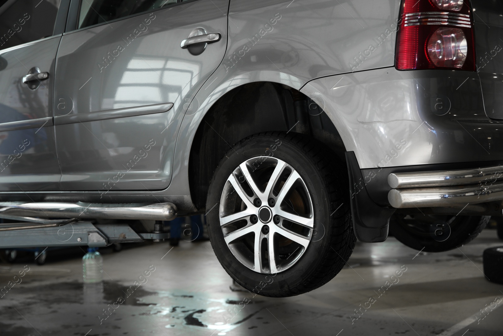 Photo of Modern car waiting for diagnostic at automobile repair shop, closeup