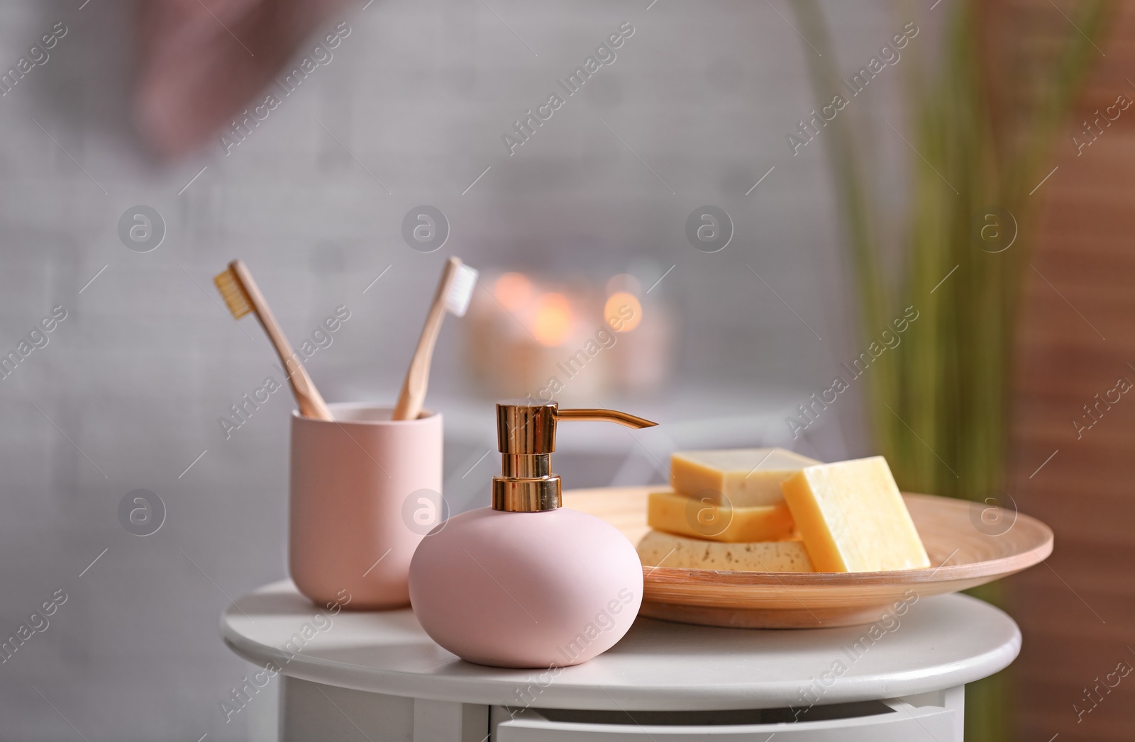 Photo of Aromatic soap and shampoo on table against blurred background. Space for text