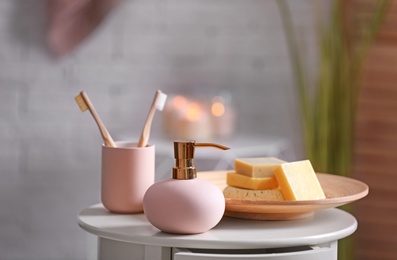 Photo of Aromatic soap and shampoo on table against blurred background. Space for text