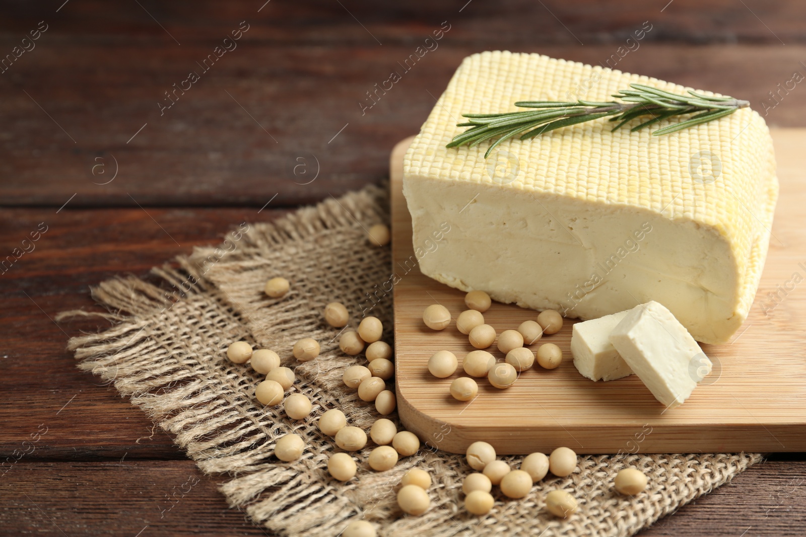 Photo of Delicious tofu with rosemary and soy on wooden table. Space for text