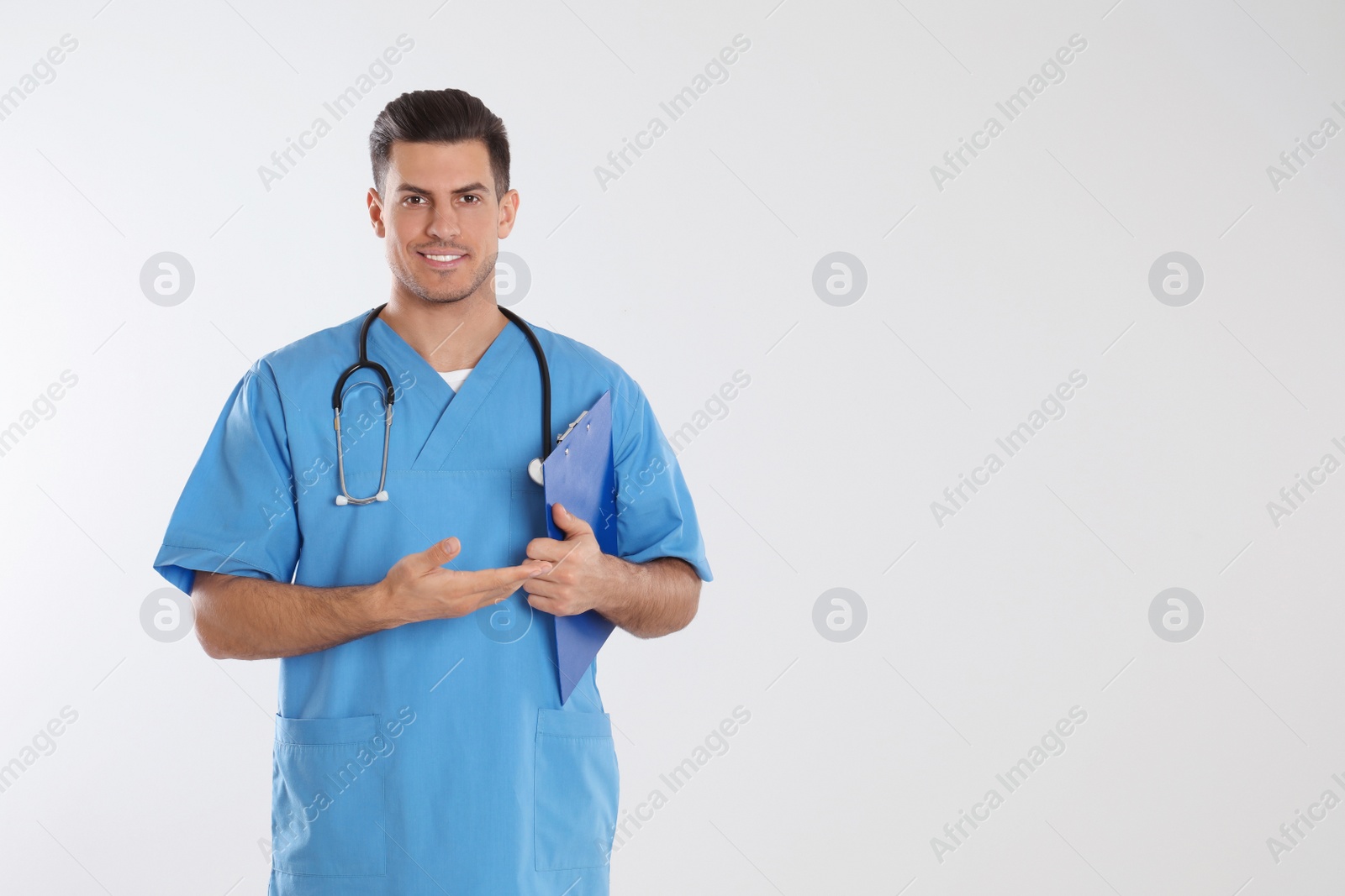 Photo of Doctor with stethoscope and clipboard on light grey background. Space for text