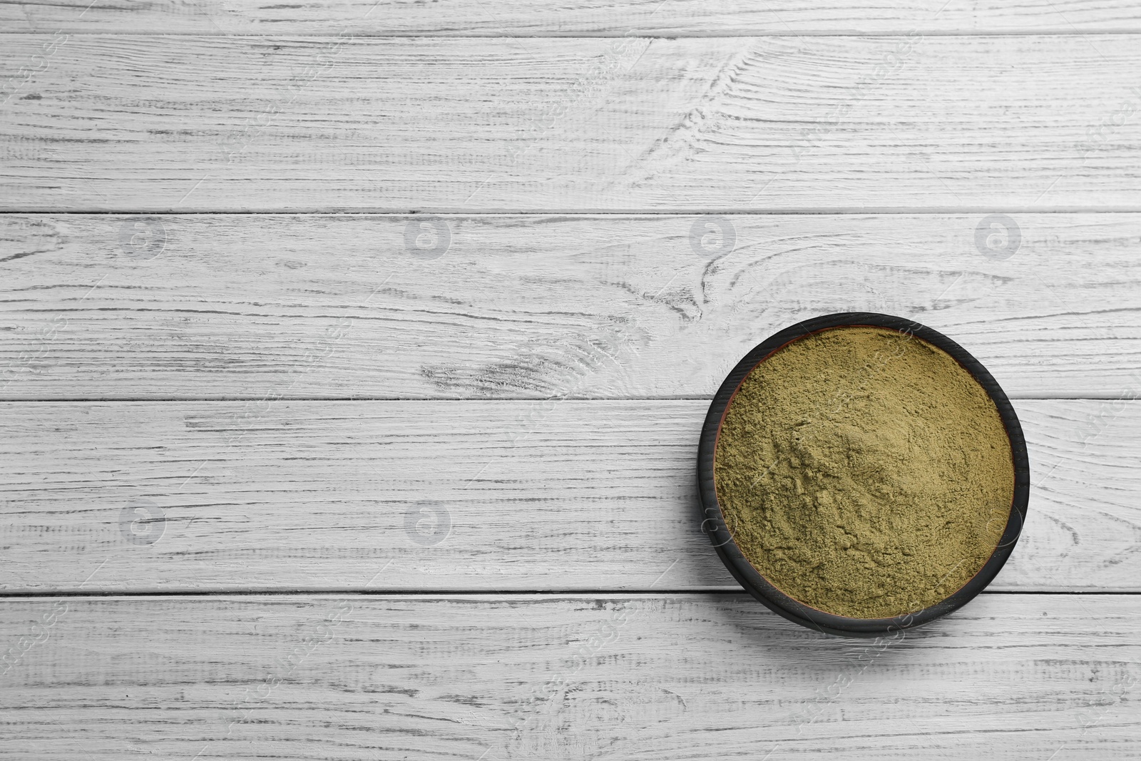 Photo of Hemp protein powder in dishware on wooden table. Space for text