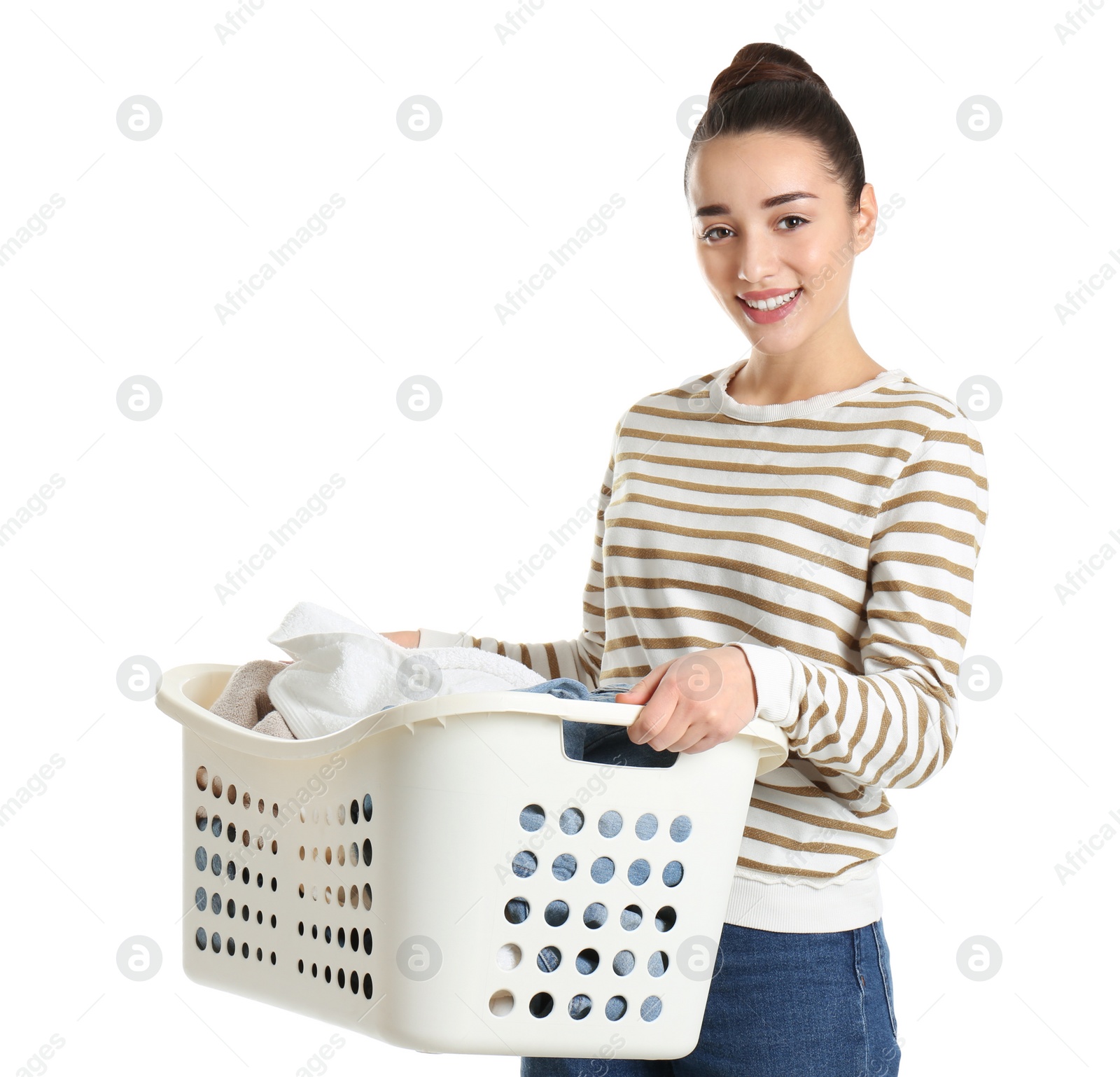 Photo of Happy young woman holding basket with laundry on white background