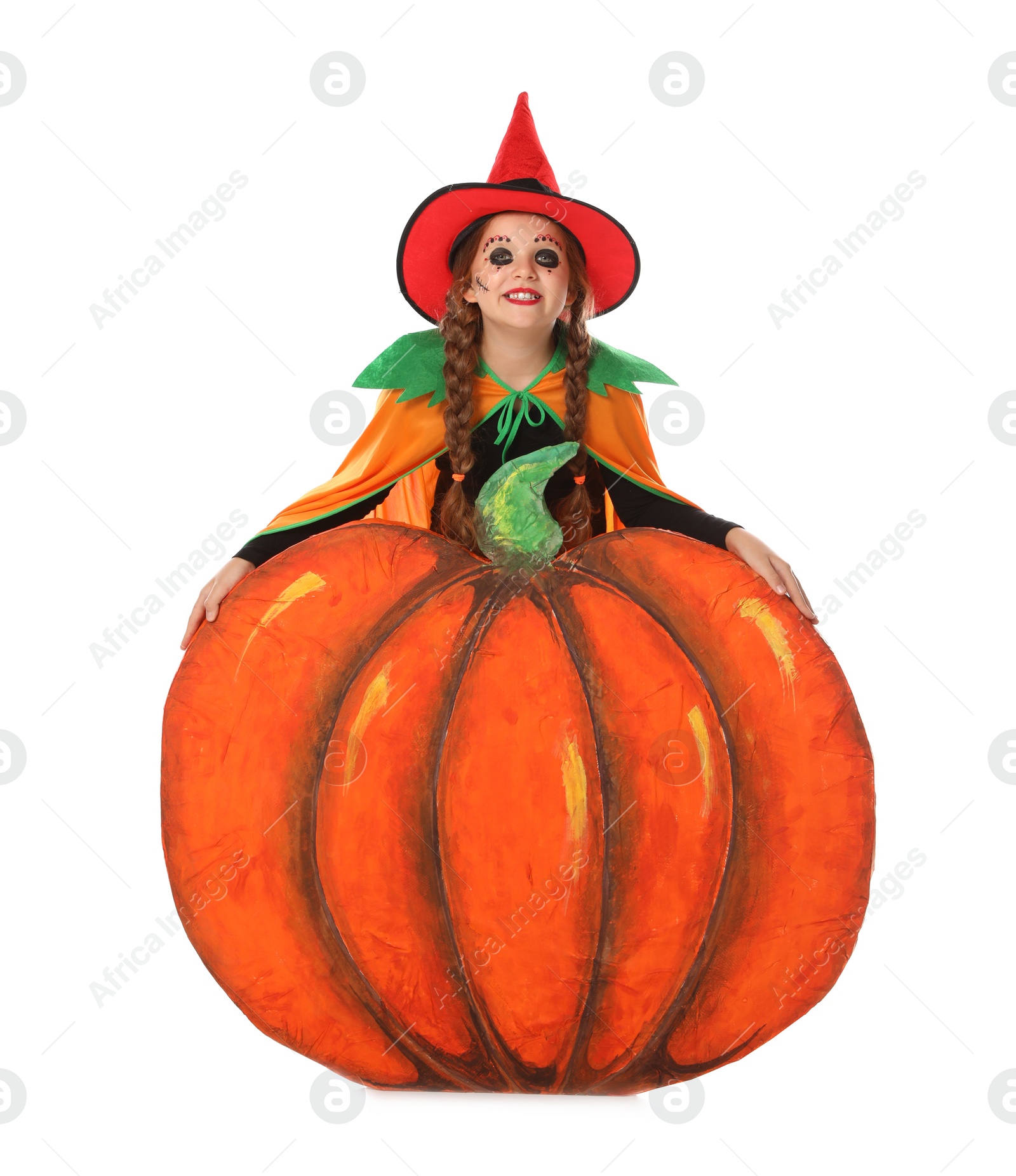 Photo of Cute little girl wearing Halloween costume and decorative pumpkin on white background