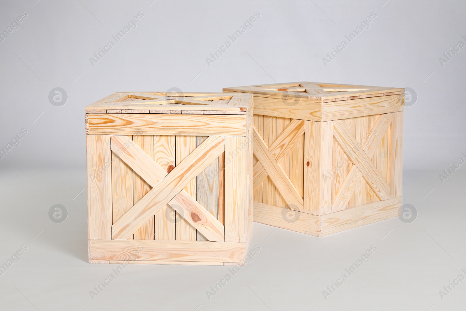 Photo of Pair of wooden crates on grey background