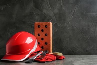 Photo of Composition with construction tools on grey table, space for text