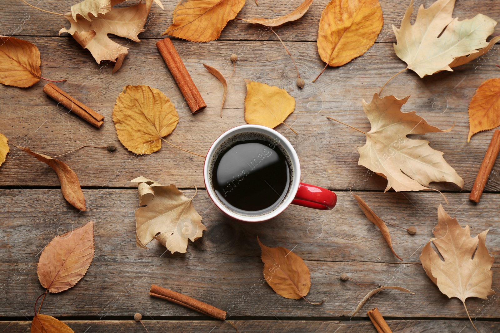 Photo of Flat lay composition with cup of hot drink on wooden table. Cozy autumn atmosphere