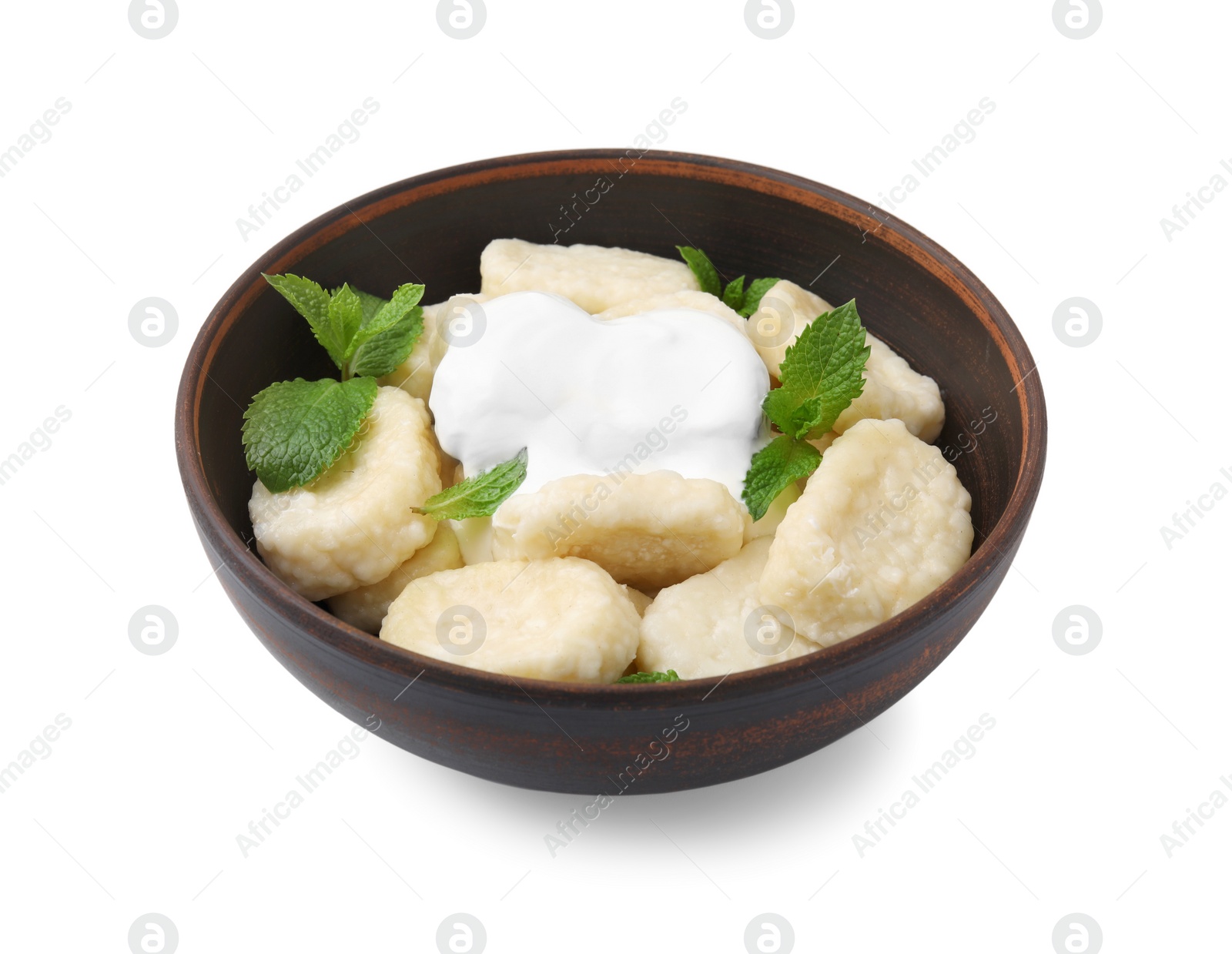 Photo of Bowl of tasty lazy dumplings with mint leaves and sour cream isolated on white