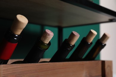 Photo of Bottles of wine with corks in crate, closeup
