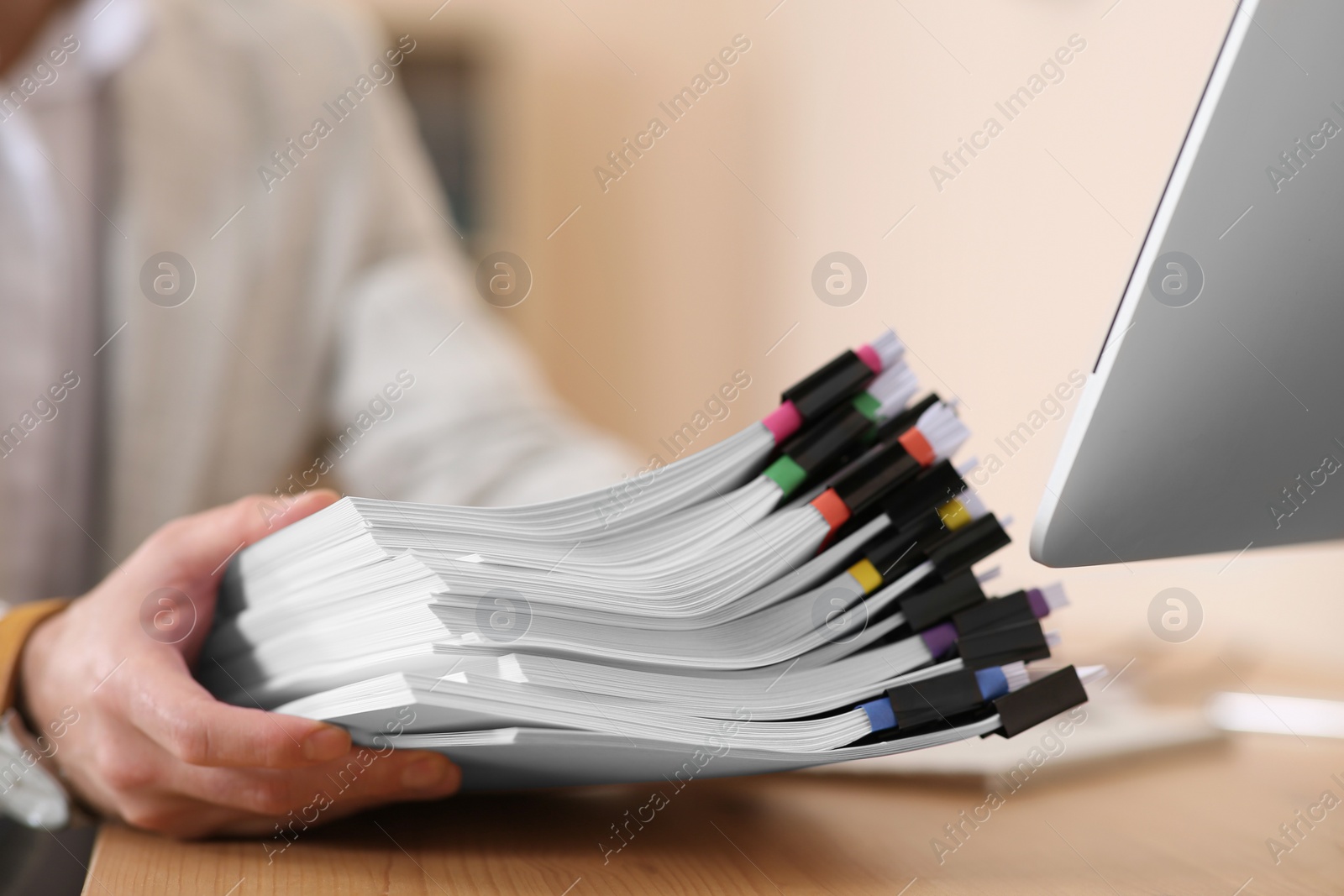 Photo of Businessman with documents at wooden table in office, closeup