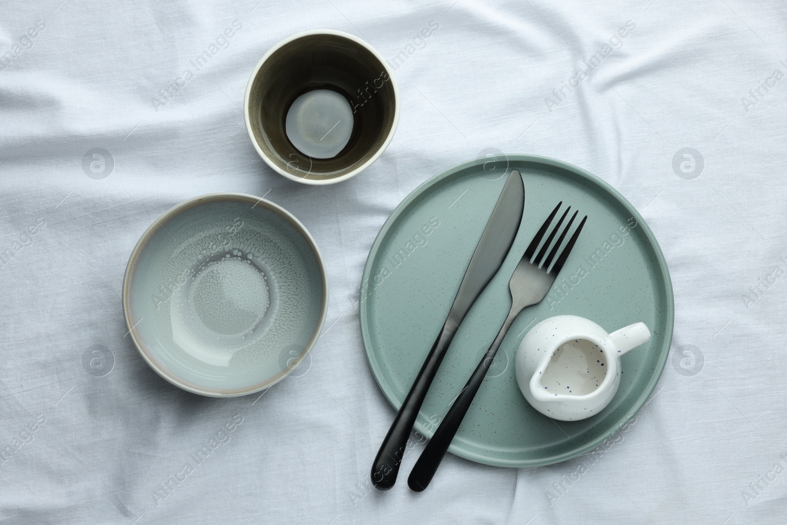 Photo of Stylish empty dishware and cutlery on table, flat lay