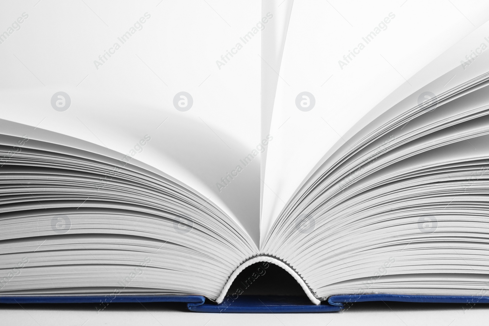 Photo of Closeup view of open book on white background