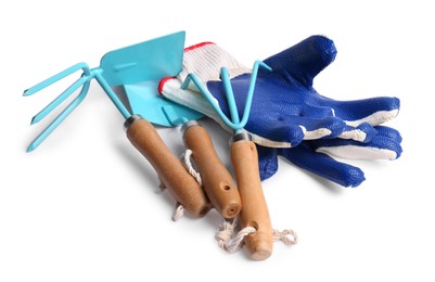 Pair of gloves and gardening tools on white background