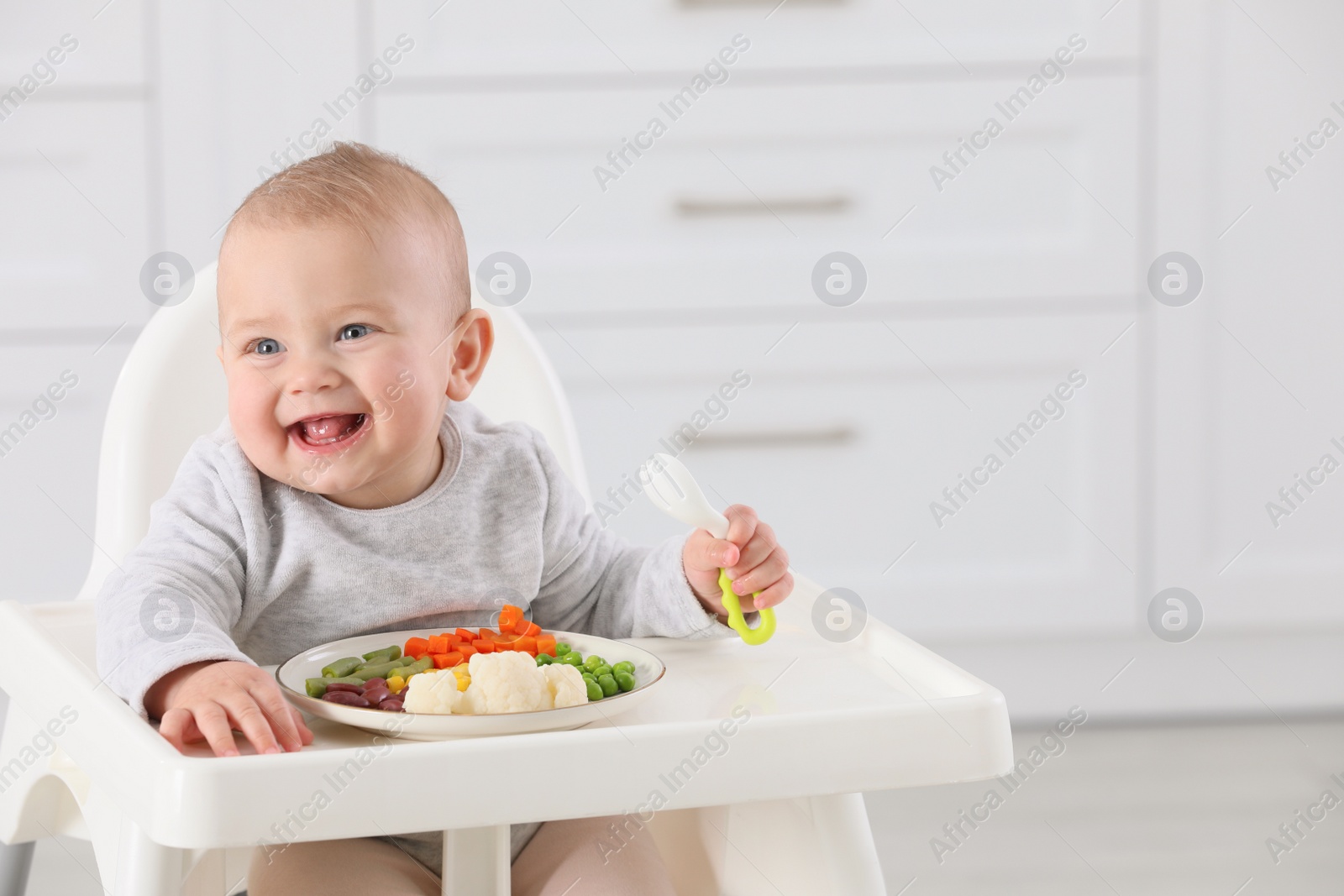 Photo of Cute little baby eating healthy food at home. Space for text