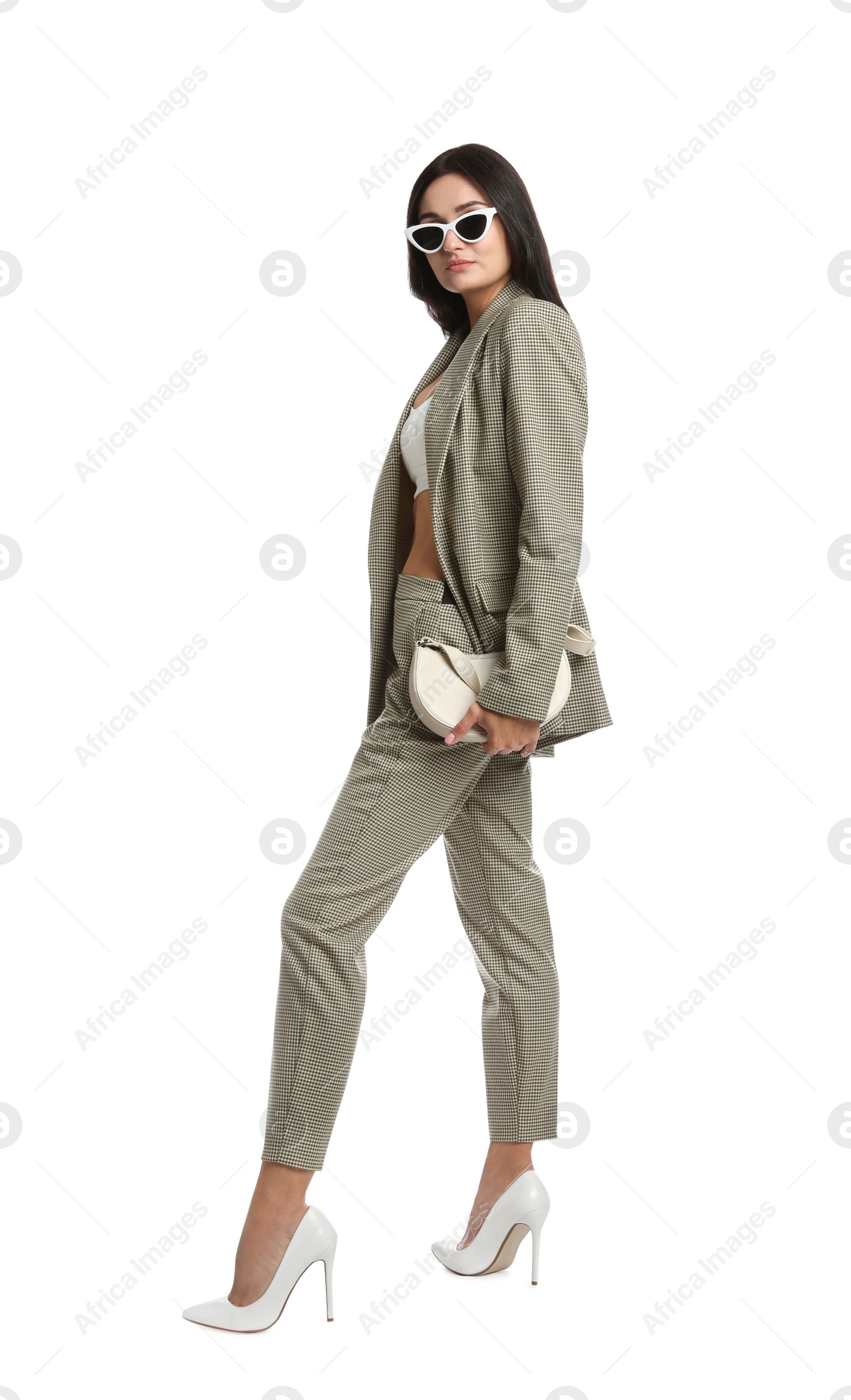 Photo of Full length portrait of beautiful woman with sunglasses and bag in formal suit on white background