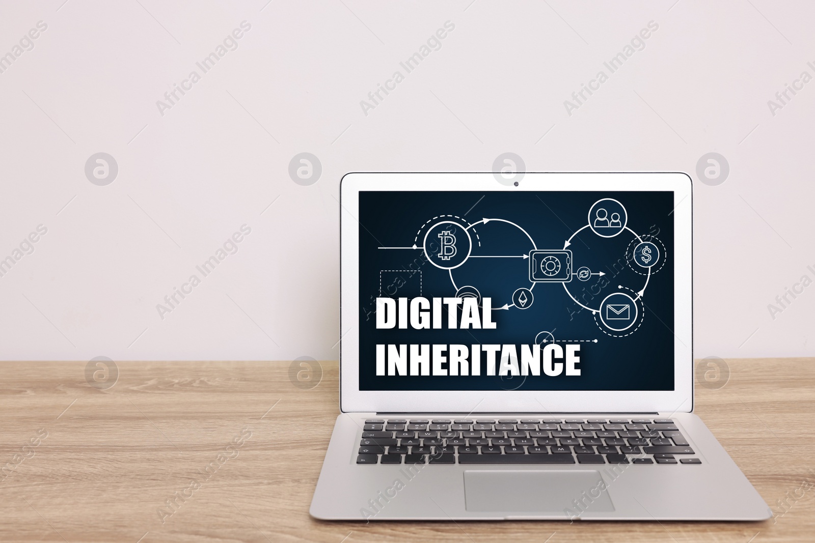 Image of Laptop with text Digital Inheritance and scheme with many different icons on screen. Workplace with device on wooden table
