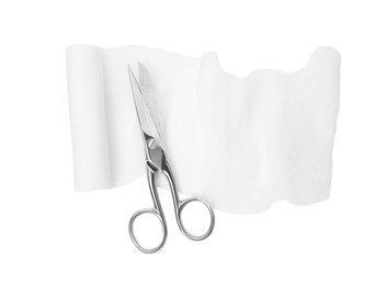 Photo of Medical bandage and scissors on white background, top view