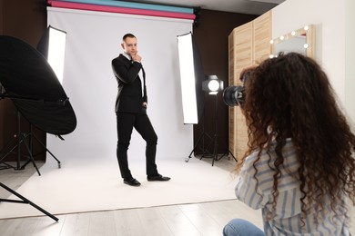 Handsome model posing for professional photographer in studio