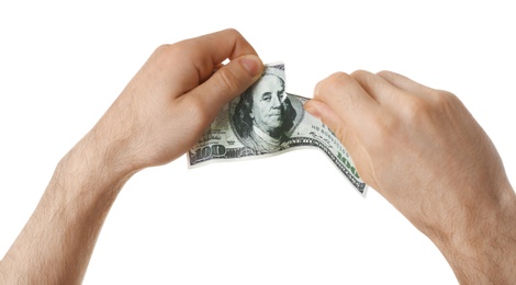 Photo of Man tearing dollar bill on white background, closeup