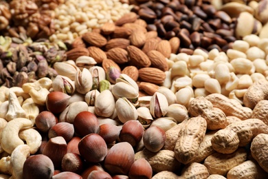 Photo of Organic mixed nuts as background, closeup. Healthy snack