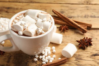 Tasty hot chocolate with marshmallows on wooden table, closeup