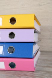Photo of Stack of office folders on white wooden table, closeup