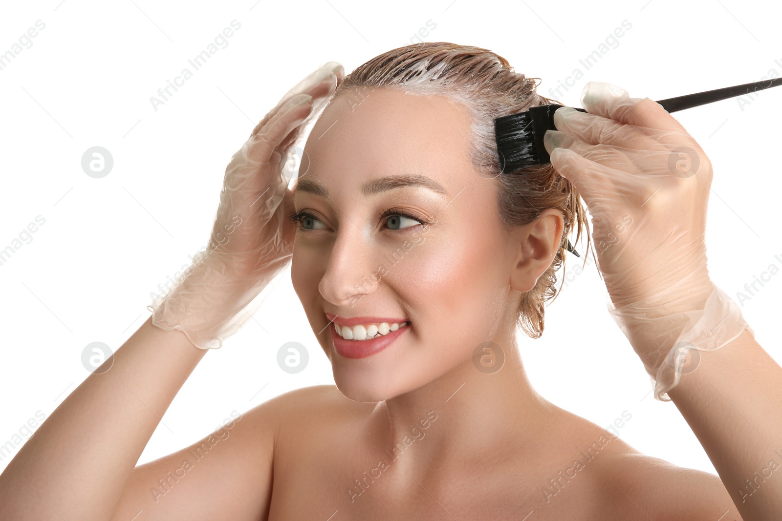 Photo of Young woman dyeing her hair against white background