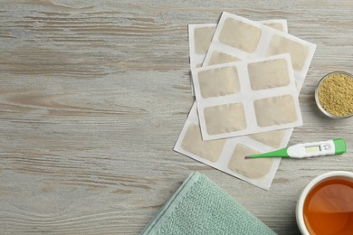 Flat lay composition with mustard plasters on wooden table. Space for text