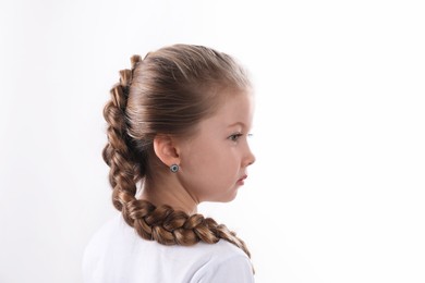 Little girl with braided hair on white background. Space for text