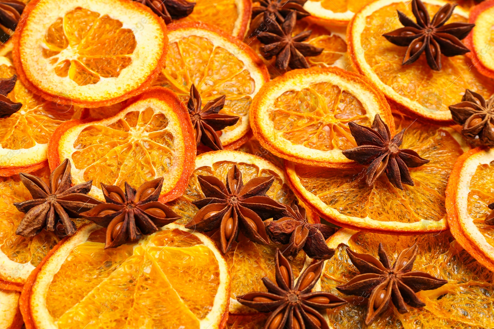 Photo of Dry orange slices and anise stars as background, closeup