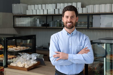 Photo of Portrait of happy business owner in bakery shop