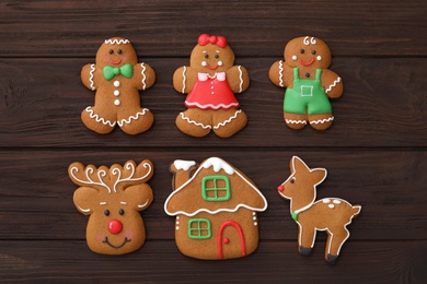 Photo of Different delicious Christmas cookies on wooden table, flat lay