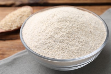 Glass bowl with quinoa flour on table, closeup