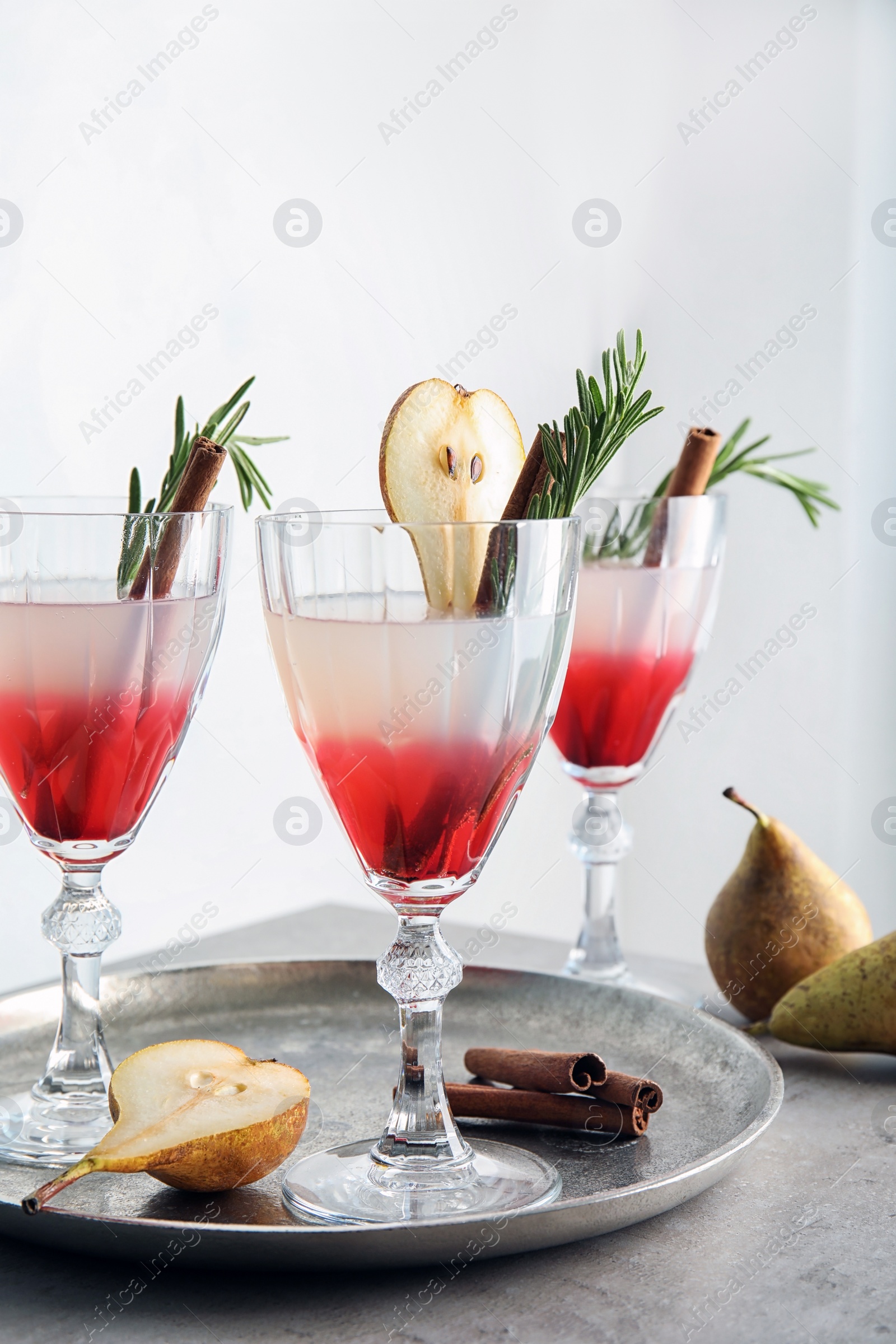 Photo of Tasty refreshing pear cocktail with rosemary on table