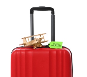 Red suitcase with TRAVEL INSURANCE label on white background