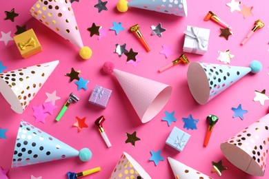 Flat lay composition with party hats on pink background