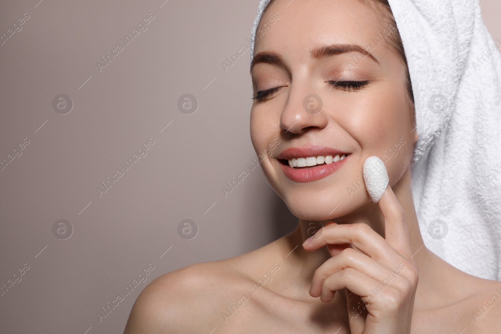 Photo of Woman using silkworm cocoon in skin care routine on light grey background. Space for text