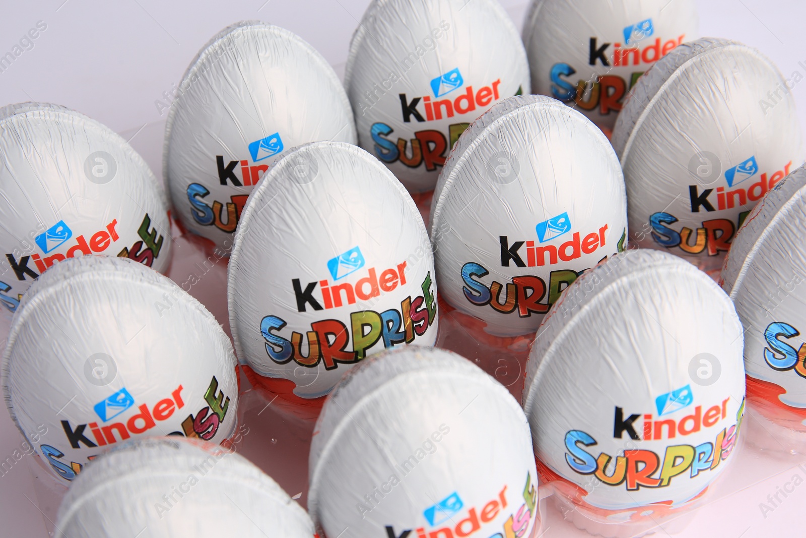 Photo of Sveti Vlas, Bulgaria - June 26, 2023: Kinder Surprise Eggs in plastic tray on white background, closeup