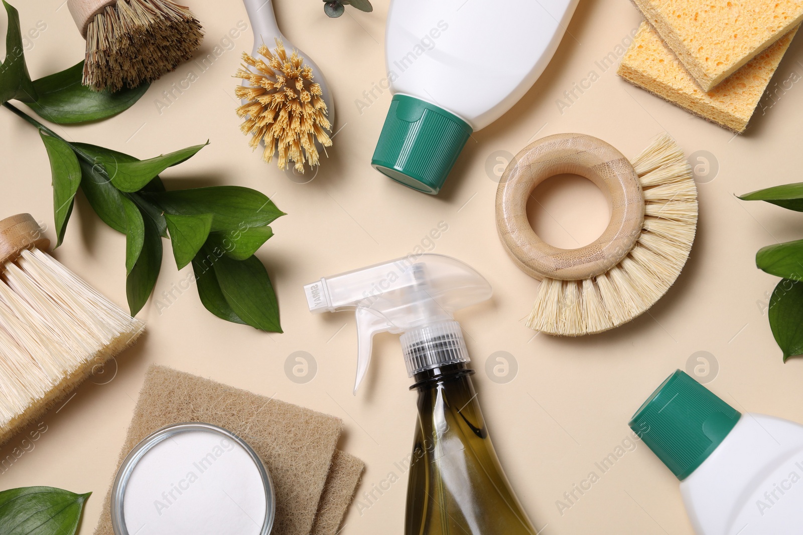 Photo of Flat lay composition with different cleaning supplies on beige background