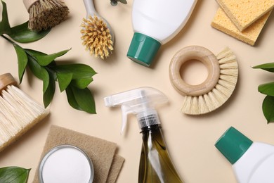 Flat lay composition with different cleaning supplies on beige background