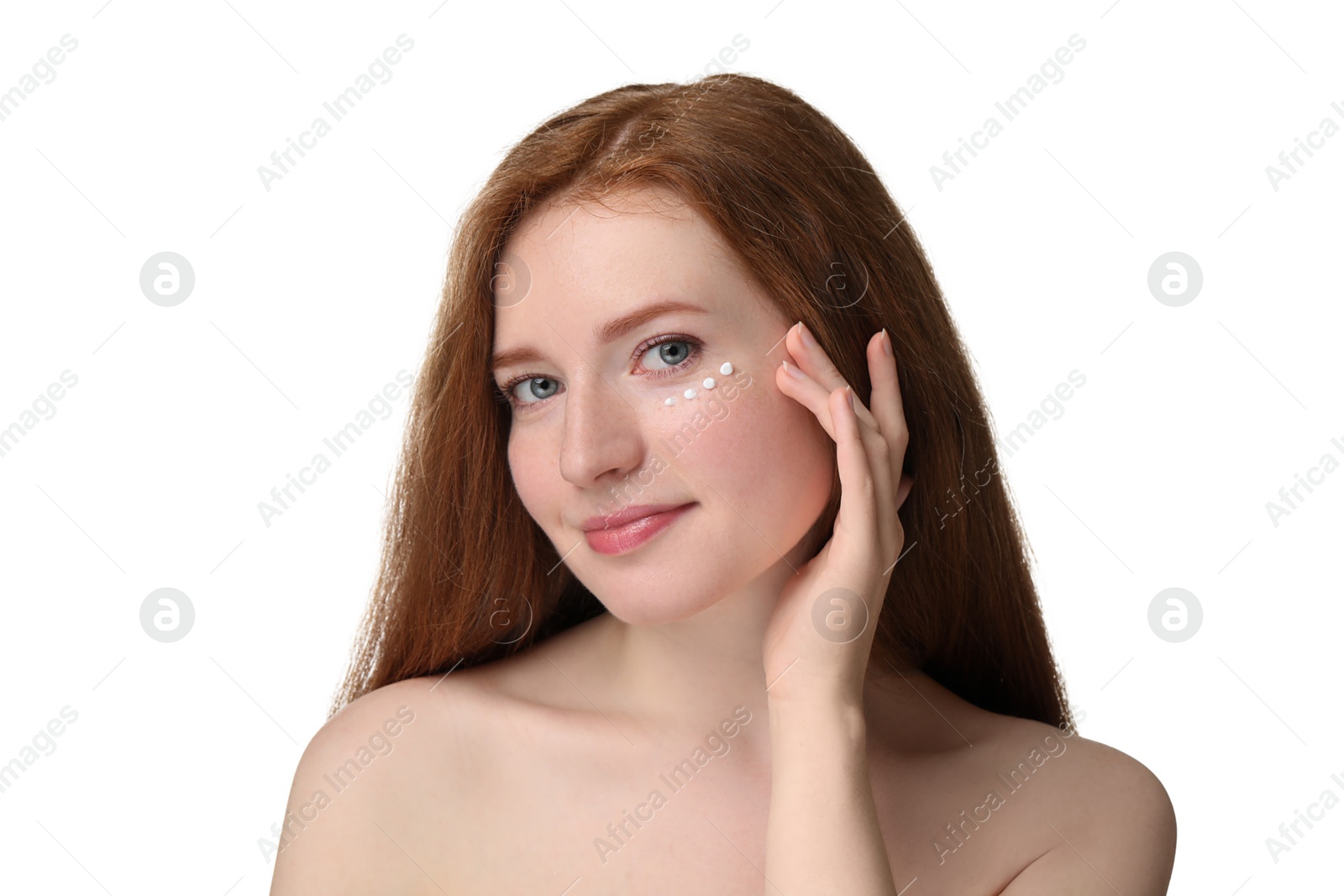 Photo of Beautiful woman with freckles and cream on her face against white background