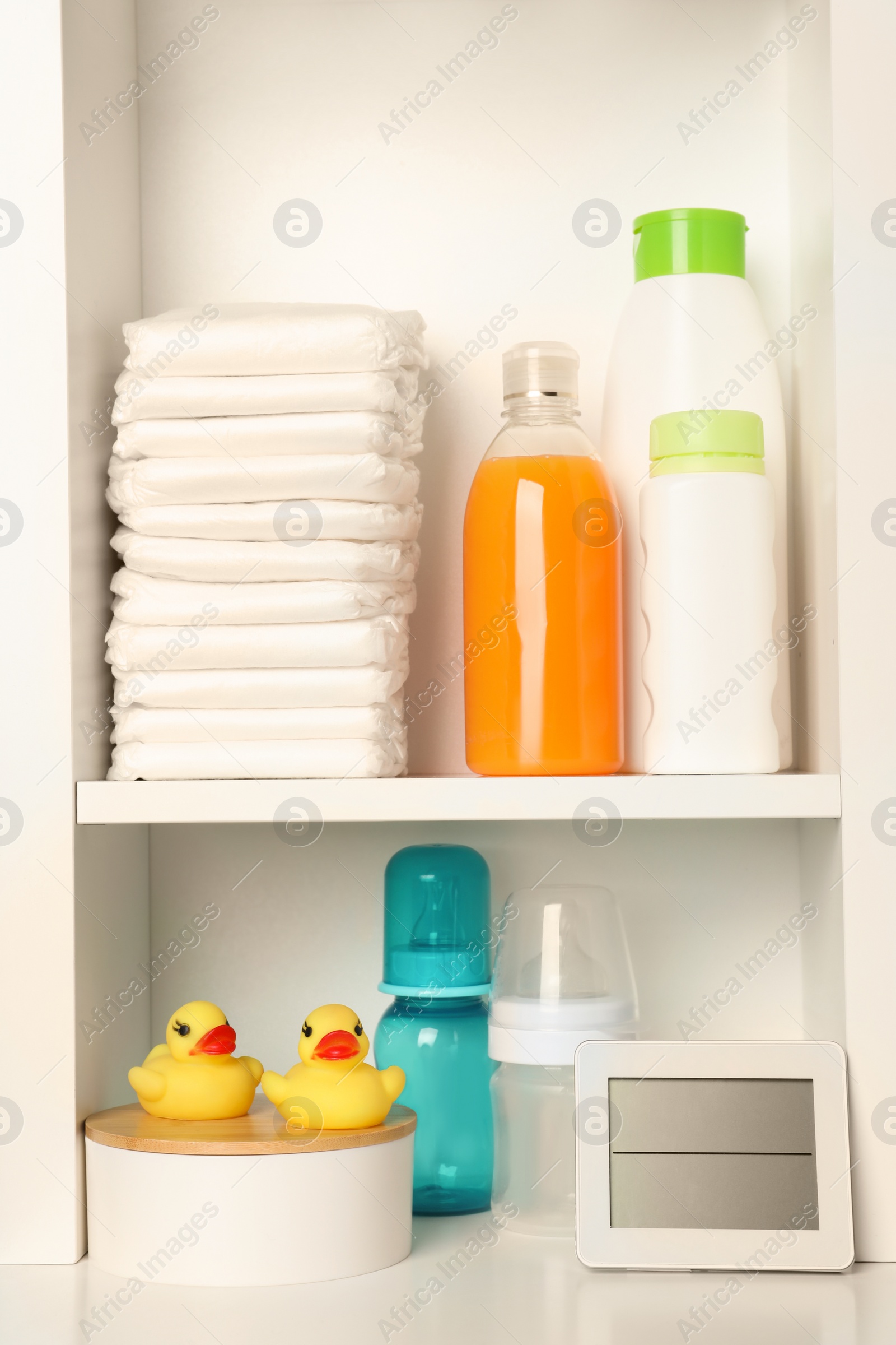 Photo of Toys and baby accessories on white rack