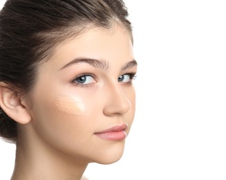 Photo of Beautiful girl with foundation smear on her face against white background